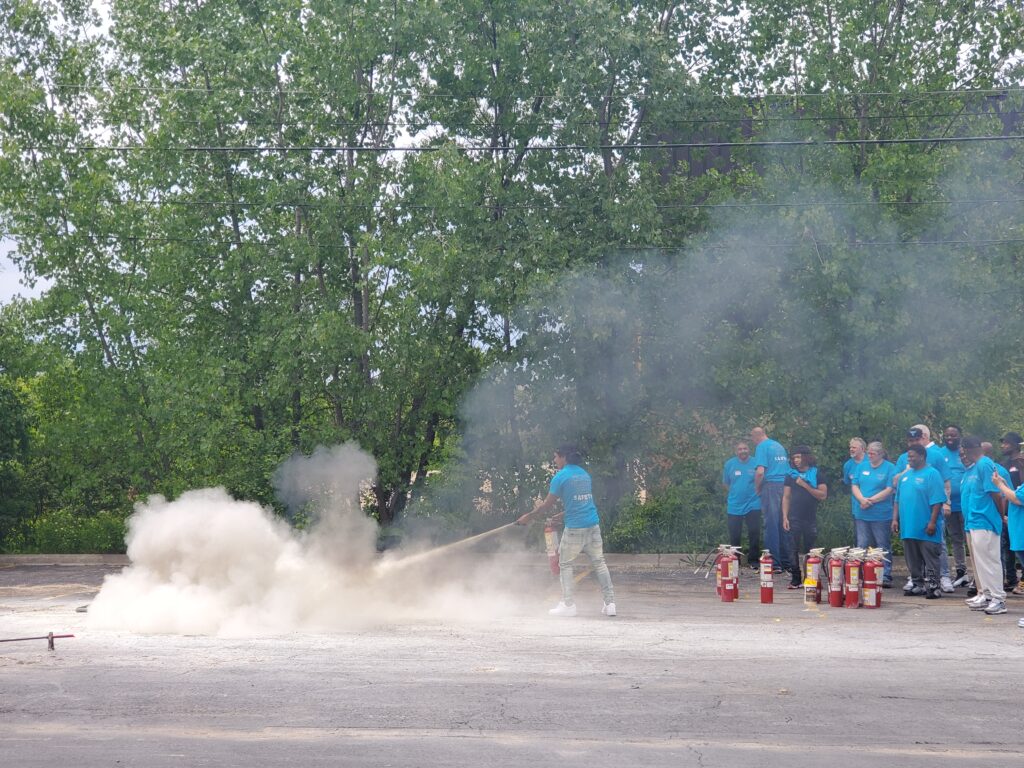 A Denali Ingredients employee puts out a controlled fire.